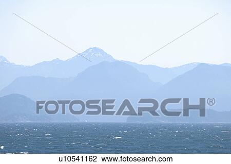 Stock Image - BC's Coast mountains as seen from a BC Ferry in the Strait of Georgia. Fotosearch