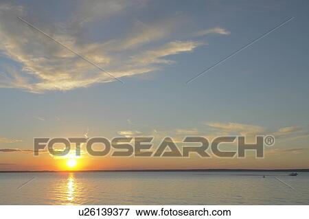 Stock Photo - Clear Lake at sunset; Canada, Manitoba, Riding Mountain National Park. Fotosearch