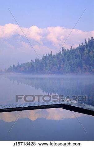 Stock Photo - One Mile Lake, near Pemberton, BC in early morning mist. Fotosearch