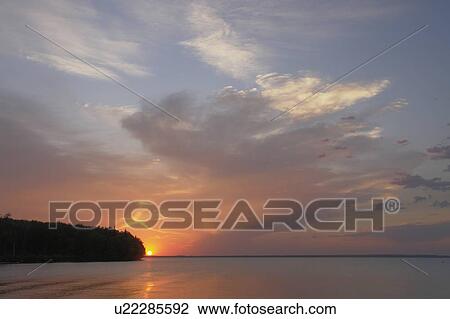 Stock Image - Sunset Clear Lake; Canada, Manitoba, Riding Mountain National Park. Fotosearch