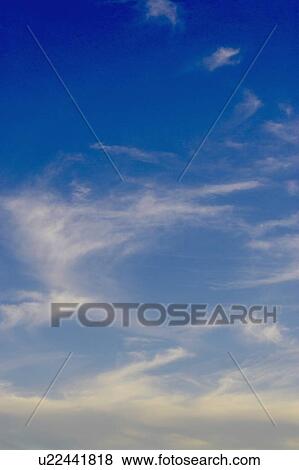 Stock Photo - Deep blue sky scape with wispy clouds, Drumbo, Ontario. Fotosearch
