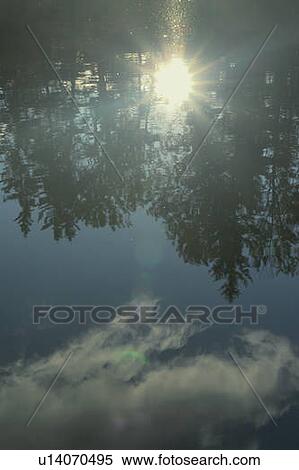 Stock Photography - Reflection of clouds in Clear Lake, Riding Mountain National Park; Canada: Manitoba. Fotosearch
