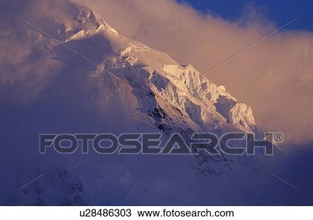 Stock Image - Seracs on a ridge next to the Grand Pacific Glacier in stormy changing weather, Alaska. Fotosearch