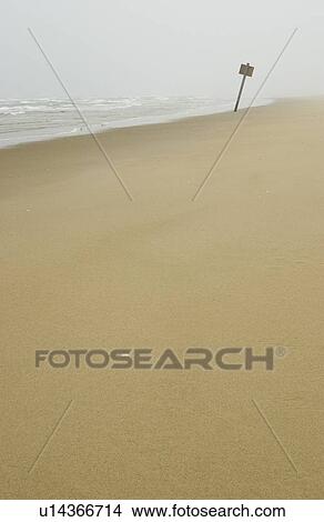 Picture - Sign on flat sandy beach with mist in the background, Reedsport, Oregon. Fotosearch