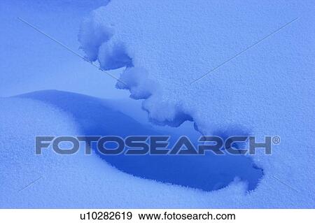 Stock Photo - Snow and ice patterns on the Mistaya River Banff National Park Alberta Canada. Fotosearch