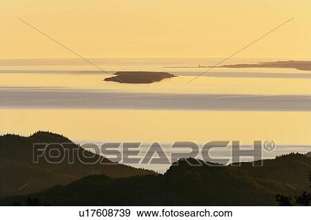 View of island and St. Lawrence river at sunrise, Bas-Saint-Laurent region, Quebec, Canada. View Large Photo Image Stock Photo - View of island and St. Lawrence river at sunrise, Bas-Saint-Laurent region, Quebec, Canada.. Fotosearch