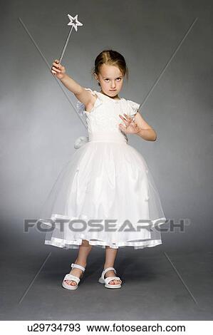 Stock Image - 5 year old girl in white dress. Fotosearch