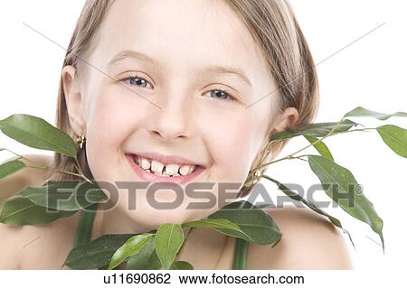 9 year old girl with the green leaves under her chin View Large Photo Image Stock Image - 9 year old girl with the green leaves under her chin. Fotosearch