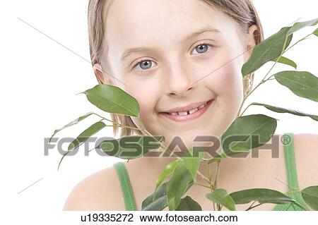 9 year old girl with the green leaves under her chin View Large Photo Image Stock Image - 9 year old girl with the green leaves under her chin. Fotosearch