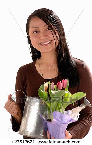 Asian Young girl w/watering can View Large Photo Image Stock Image - Asian Young girl w/watering can. Fotosearch