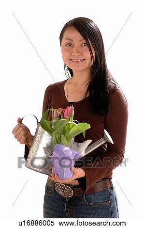 Asian Young girl w/watering can, Regina, Saskatchewan View Large Photo Image Stock Photography - Asian Young girl w/watering can, Regina, Saskatchewan. Fotosearch