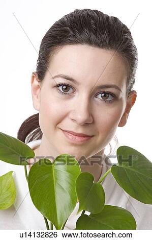 Stock Photograph - face of a young woman with leaves. Fotosearch