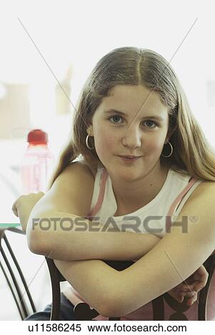 Stock Photography - Portrait of pre-teen girl, wearing shirt made with hemp fibre, with reusable water bottle, Canada, Manitoba, Brandon. Fotosearch