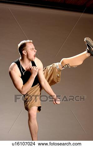 Portrait of young man (21 years of age) doing high kick with his prosthesis; Canada, Saskatchewan, Regina View Large Photo Image Picture - Portrait of young man (21 years of age) doing high kick with his prosthesis; Canada, Saskatchewan, Regina. Fotosearch