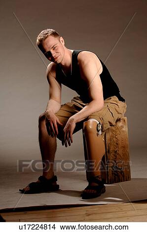 Portrait of young man (21 years of age) showing his prosthesis, having lost lower leg to cancer; Canada, Saskatchewan, Regina View Large Photo Image Picture - Portrait of young man (21 years of age) showing his prosthesis, having lost lower leg to cancer; Canada, Saskatchewan, Regina. Fotosearch