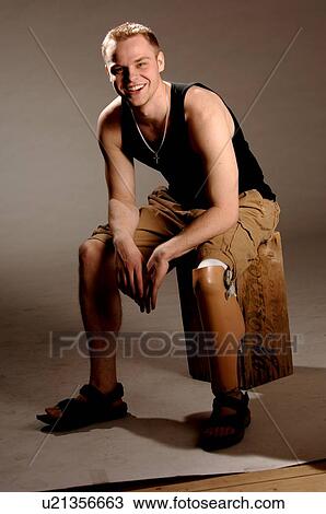 Portrait of young man (21 years of age) showing his prosthesis, having lost lower leg to cancer; Canada, Saskatchewan, Regina View Large Photo Image Stock Image - Portrait of young man (21 years of age) showing his prosthesis, having lost lower leg to cancer; Canada, Saskatchewan, Regina. Fotosearch