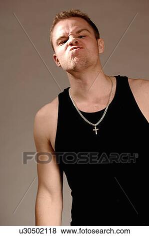 Portrait of young man (21 years of age) snarling; Canada, Saskatchewan, Regina View Large Photo Image Stock Photo - Portrait of young man (21 years of age) snarling; Canada, Saskatchewan, Regina. Fotosearch