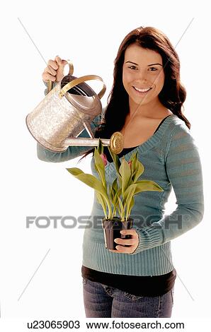 Stock Image - Young girl w/ watering can/Flower, Regina, Saskatchewan. Fotosearch