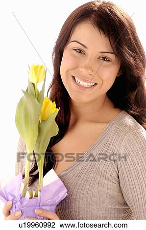 Stock Image - Young girl w/Flower, Regina, Saskatchewan. Fotosearch