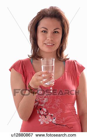 Stock Photo - Young girl w/water glass, Regina, Saskatchewan. Fotosearch