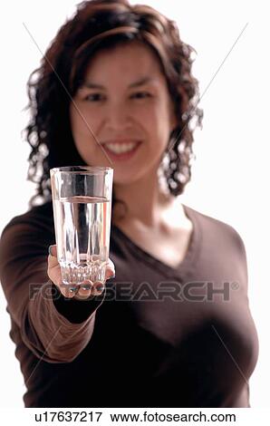 Stock Photo - Young girl w/water glass, Regina, Saskatchewan. Fotosearch