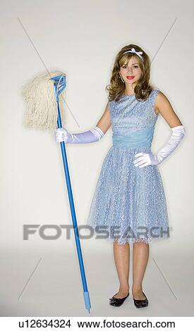 Young woman wearing 50's style dress holding a mop View Large Photo Image Picture - Young woman wearing 50's style dress holding a mop. Fotosearch