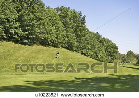 Golfer swinging from the rough of a golf course, Canada, Ontario, Burlington View Large Photo Image Stock Image - Golfer swinging from the rough of a golf course, Canada, Ontario, Burlington. Fotosearch