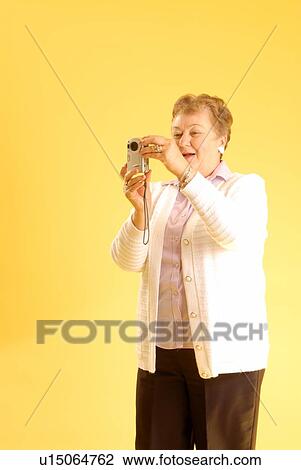 Stock Image - Senior Woman camera; Canada, Saskatchewan, Regina. Fotosearch