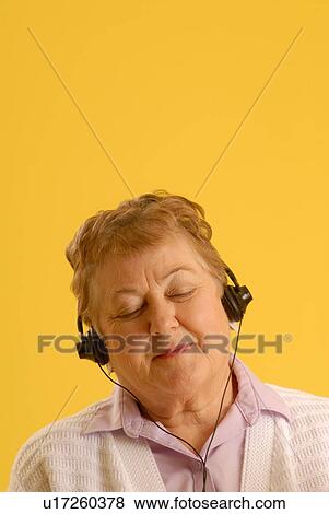 Stock Photo - Senior Woman headphones, Regina, Saskatchewan. Fotosearch