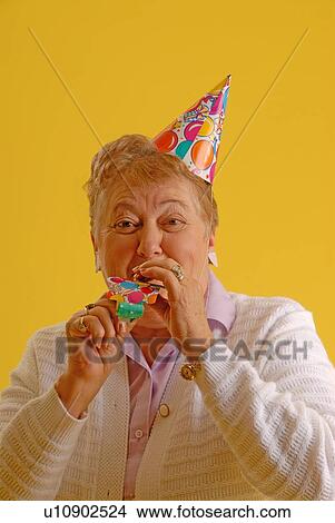 Picture - Senior Woman party hat; Canada, Saskatchewan, Regina. Fotosearch