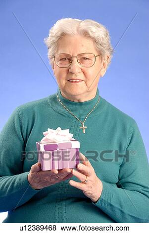 Senior Woman with Gift; Canada, Saskatchewan, Regina View Large Photo Image Stock Photo - Senior Woman with Gift; Canada, Saskatchewan, Regina. Fotosearch