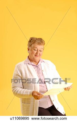 Stock Photography - Senior Woman with letter; Canada, Saskatchewan, Regina. Fotosearch