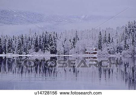 Stock Photograph - Early winter snow greys the trees, reflection in lake, Alta Lake, Whistler, B. C.. Fotosearch