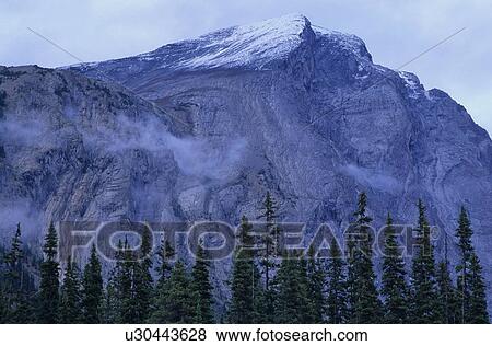 Mountain ridge with cloud cover and snow patched, Athabasca Pass, Jasper National Park View Large Photo Image Stock Photo - Mountain ridge with cloud cover and snow patched, Athabasca Pass, Jasper National Park. Fotosearch
