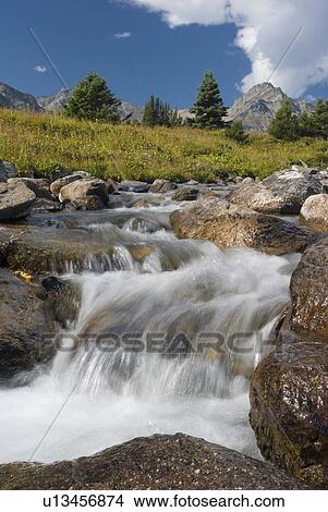 A waterfall flows through an alpine meadow, Skyline Trail, Jasper National Park, Alberta, Canada. View Large Photo Image Picture - A waterfall flows through an alpine meadow, Skyline Trail, Jasper National Park, Alberta, Canada.. Fotosearch