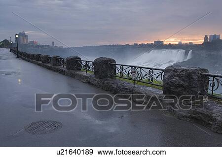 Sunrise over the American Falls with the Niagara Falls promenade in the foreground - Niagara Falls, Ontario, Canada View Large Photo Image Stock Photo - Sunrise over the American Falls with the Niagara Falls promenade in the foreground - Niagara Falls, Ontario, Canada. Fotosearch