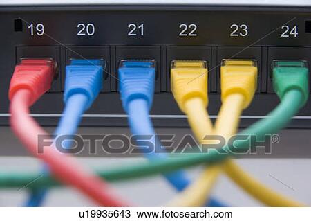 Stock Image - Computer Cables Connected To A Router. Fotosearch