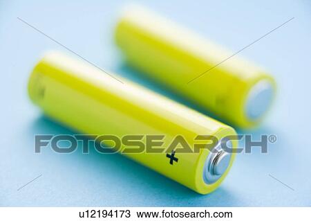 Two Yellow Batteries Against A Blue Background View Large Photo Image Stock Image - Two Yellow Batteries Against A Blue Background. Fotosearch