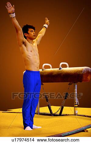 Young man practicing gymnastics on the pommel horse View Large Photo Image Picture - Young man practicing gymnastics on the pommel horse. Fotosearch