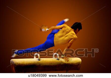 Young man practicing gymnastics on the pommel horse View Large Photo Image Stock Photo - Young man practicing gymnastics on the pommel horse. Fotosearch