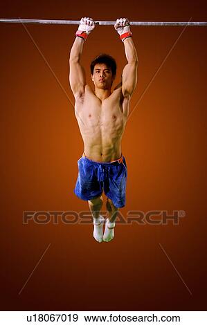 Young man practicing on the horizontal bar View Large Photo Image Stock Photo - Young man practicing on the horizontal bar. Fotosearch