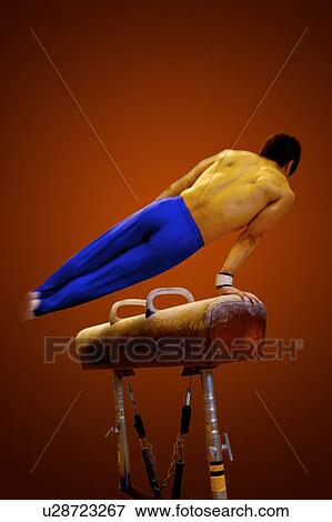 Young man practicing on the pommel horse View Large Photo Image Stock Photo - Young man practicing on the pommel horse. Fotosearch