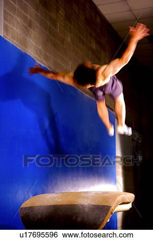 Young man practicing on the vaulting horse View Large Photo Image Stock Photograph - Young man practicing on the vaulting horse. Fotosearch