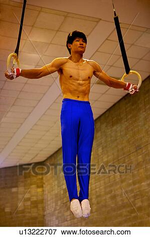 Young man practicing the gymnastic rings View Large Photo Image Stock Photo - Young man practicing the gymnastic rings. Fotosearch