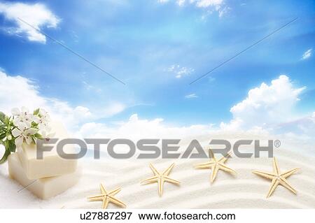 Stock Illustration - Four starfishes on sand and flowers on two bars of soap in clear sky (composite). Fotosearch