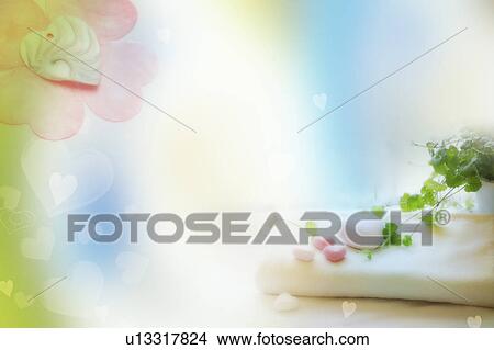 Stock Illustration - Heart-shaped soap on folded towel beside a potted plant (composite). Fotosearch