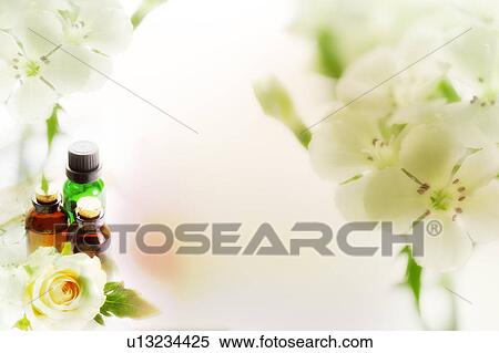 Stock Illustration - Three bottles of aromatherapy oils with flowers (composite). Fotosearch