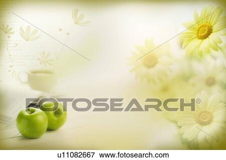 Stock Illustration - Two green apples and a cup of tea beside a book with flower background (composite). Fotosearch