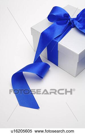 Stock Photography - Close-up of a wrapped box with blue ribbon. Fotosearch
