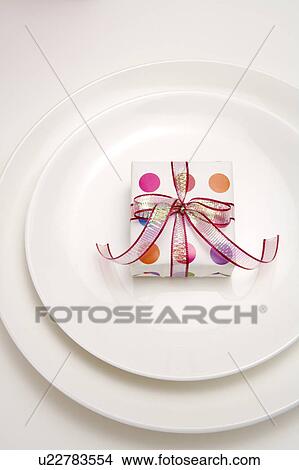 Close-up of a wrapped present on the plate View Large Photo Image Picture - Close-up of a wrapped present on the plate. Fotosearch